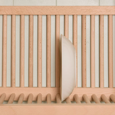Close up of the top shelf of a plate rack showing a bowl being stored ready for use. 